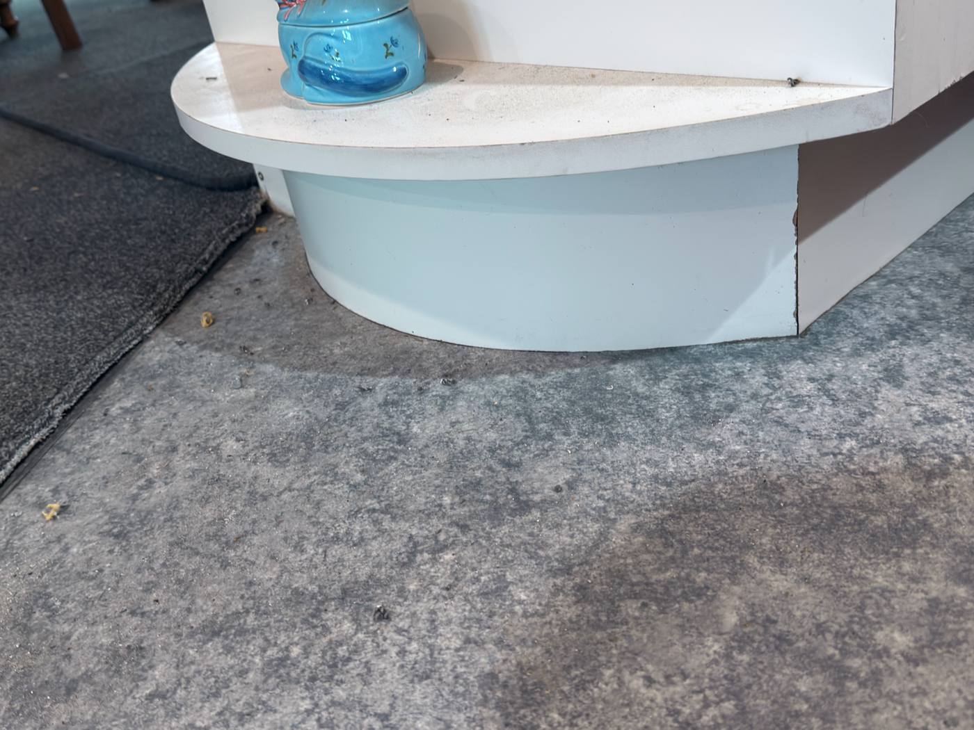 Bare subfloor around a curved bench base before installation