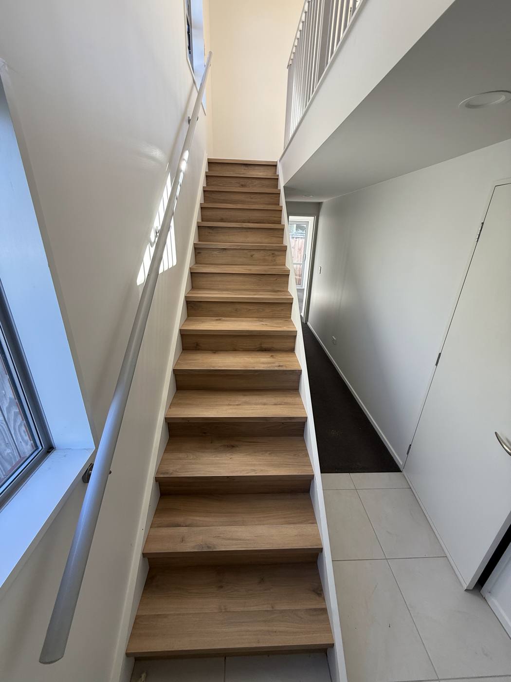 Straight staircase finished in oak-look treads and risers